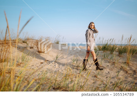 Fashion Model posing near the sea. Young woman resting in nature. People, lifestyle, relaxation. 105534789