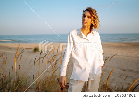 Stylish woman enjoying autumn weather outdoor. Fashion, style concept. People, lifestyle, relaxation 105534801