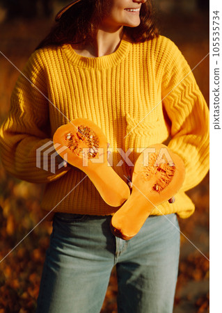 Young woman in a yellow sweater and jeans resting in nature. Fashion, style concept. People, lifestyle. 105535734