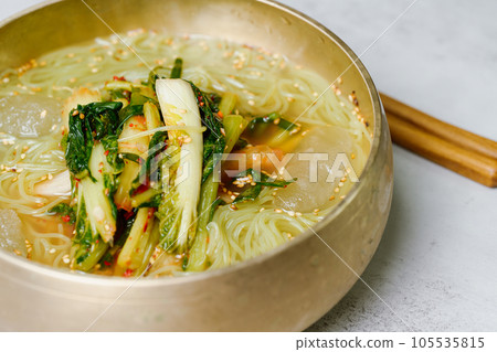 Yeolmunaengmyeon, korean style Buckwheat Noodles with YoungSummer Radish Kimchi, This dish features cold noodles in kimchi soup that is made by mixing salted young radish with chopped onion, chives, p Yeolmunaengmyeon, korean style Buckwheat Noodles with YoungSummer Radish Kimchi, This dish features cold noodles in kimchi soup that is made by mixing salted young radish with chopped onion, chives, p 105535815