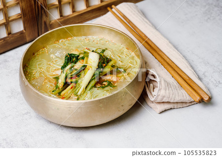 Yeolmunaengmyeon, korean style Buckwheat Noodles with YoungSummer Radish Kimchi, This dish features cold noodles in kimchi soup that is made by mixing salted young radish with chopped onion, chives, p 105535823
