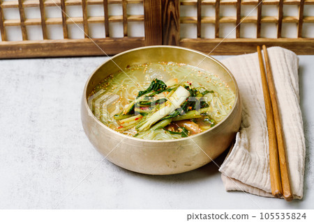 Yeolmunaengmyeon, korean style Buckwheat Noodles with YoungSummer Radish Kimchi, This dish features cold noodles in kimchi soup that is made by mixing salted young radish with chopped onion, chives, p 105535824