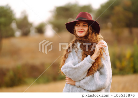 Stylish woman in hat enjoying autumn weather in the park. Fashion, style concept. 105535976