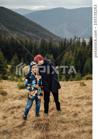 Two Brother boys stand at the top of the mountain. Ukrainian Carpathians Two Brother boys stand at the top of the mountain. Ukrainian Carpathians 105538263