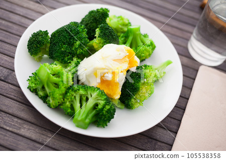 Boiled broccoli inflorescences with boiled egg in plate Boiled broccoli inflorescences with boiled egg in plate 105538358