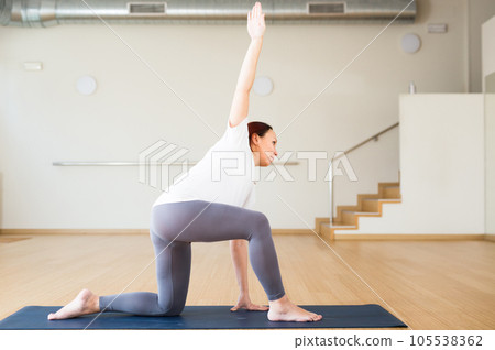 Pregnant woman does yoga in the gym 105538362
