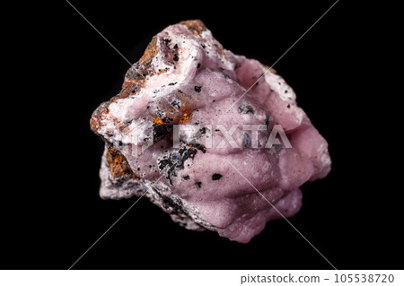 Macro pink Smithsonite mineral stone on microcline on black background 105538720
