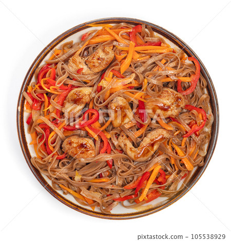 Asian fried buckwheat noodles with chicken and vegetables isolated on white background. Asian fried buckwheat noodles with chicken and vegetables isolated on white background. 105538929