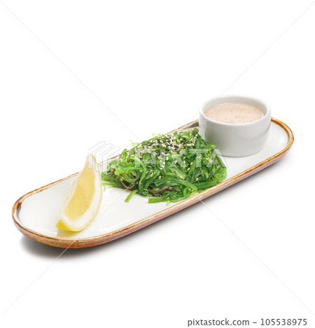 Chuka salad on a plate. Ingredients Marinated seaweed, peanut sauce, lemon, chili, sesame mix. For restaurant menu. 105538975