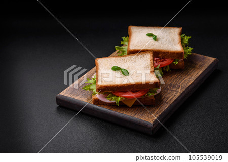 Delicious sandwich with toast, ham, tomatoes, cheese and lettuce 105539019