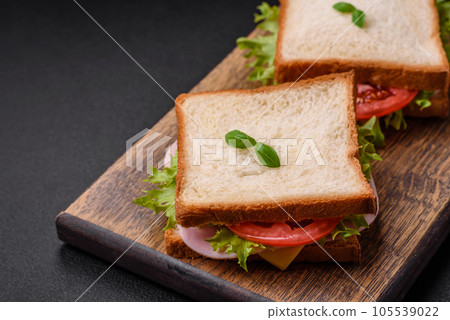 Delicious sandwich with toast, ham, tomatoes, cheese and lettuce 105539022