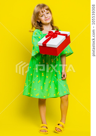 Lovely smiling preteen child girl kid presenting birthday gift box offer wrapped present celebrating Lovely smiling preteen child girl kid presenting birthday gift box offer wrapped present celebrating 105539308
