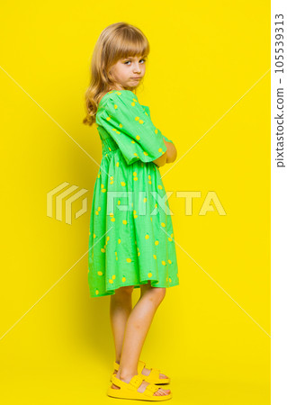 Cheerful funny bully child girl showing tongue making silly faces, fooling around, joking, teasing 105539313