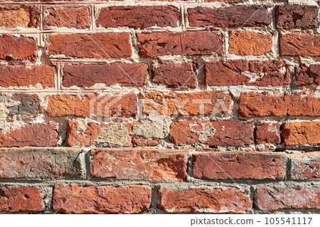 Ancient chipped wall made of red clay bricks. High quality textured background for design Ancient chipped wall made of red clay bricks. High quality textured background for design 105541117