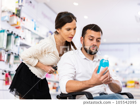 Disabled man and his wife choosing medicine 105542095