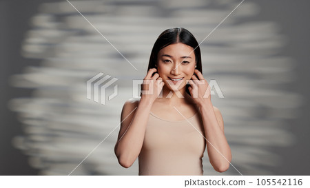 Natural beauty model with bare skin posing on camera, feeling flawless with imperfections and skincare products. Sensual woman enjoying empowering self love campaign, glowing appearance. 105542116