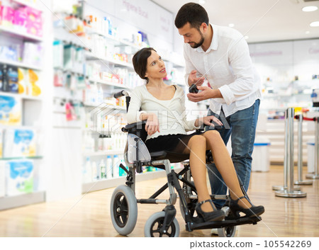 Disabled woman and her husband choosing medicine 105542269