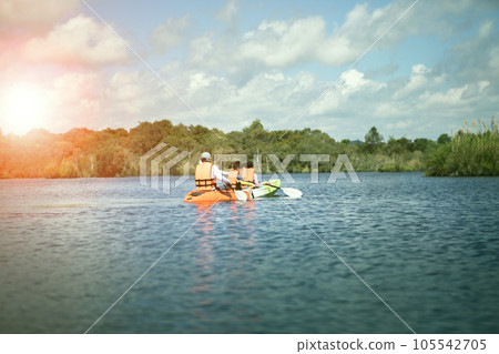 family sailing fresh water kayak in blue lagoon 105542705