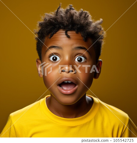 Portrait of a surprised teenage Latin American boy with open mouth and big eyes. Closeup face of shocked Latin teenager on yellow background looking at camera. Front view of amazed kid in yellow shirt 105542725