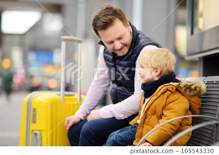 Little boy and his father waiting express train on railway station platform or waiting their flight at the airport 105543330