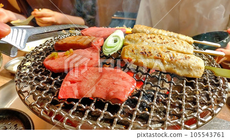 Grilling yakiniku on a charcoal grill Grilling yakiniku on a charcoal grill 105543761