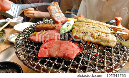 Grilling yakiniku on a charcoal grill Grilling yakiniku on a charcoal grill 105543763