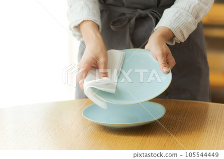 Hand photo of a woman wiping the dishes Hand photo of a woman wiping the dishes 105544449