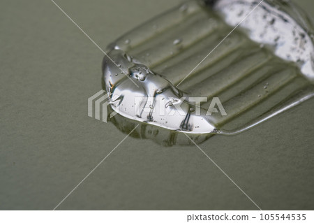 Transparent hyaluronic gel on a green background. Transparent hyaluronic gel on a green background. 105544535