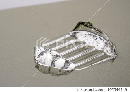 Transparent hyaluronic gel on a green background. Transparent hyaluronic gel on a green background. 105544749