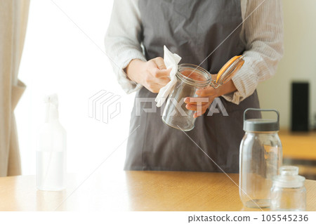 女人擦玻璃瓶的手照片 105545236