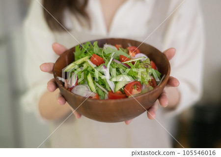woman with a bowl of salad woman with a bowl of salad 105546016