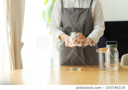 Hand photo of a woman wiping a glass bottle Hand photo of a woman wiping a glass bottle 105546319
