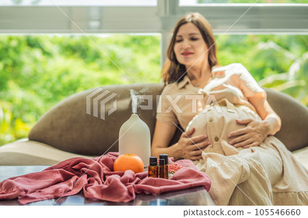 A serene moment captured as a pregnant woman after 40 embraces the soothing benefits of aroma oils and an aroma diffuser, enhancing her pregnancy journey with relaxation and tranquility 105546660