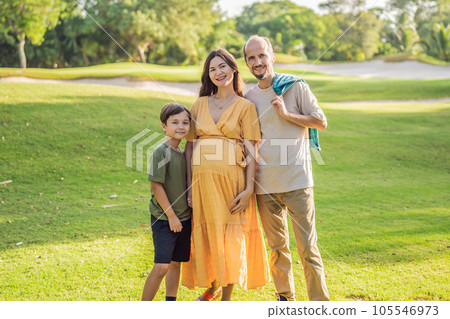 A loving family enjoying a leisurely walk in the park - a radiant pregnant woman after 40, embraced by her husband, and accompanied by their adult teenage son, savoring precious moments together A loving family enjoying a leisurely walk in the park - a radiant pregnant woman after 40, embraced by her husband, and accompanied by their adult teenage son, savoring precious moments together 105546973