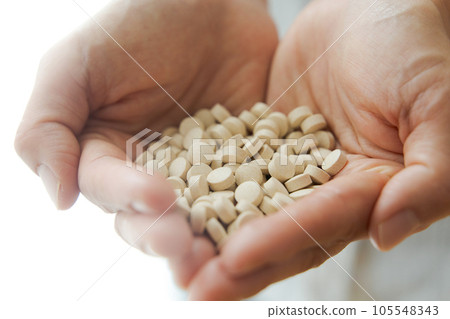 Hand photo of a woman with supplements Hand photo of a woman with supplements 105548343