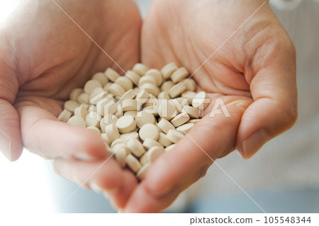 Hand photo of a woman with supplements Hand photo of a woman with supplements 105548344