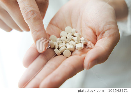 Hand photo of a woman with supplements Hand photo of a woman with supplements 105548571