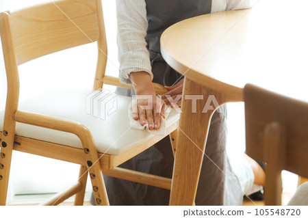 Part cut of mom wiping the chair 105548720