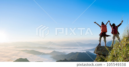 Group of happy hiker raised up arms on the mountain 105549338