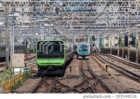 Yamanote Line E235 series and Keihin-Tohoku Line E233 series running side by side 105549516