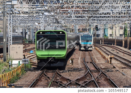 Yamanote Line E235 series and Keihin-Tohoku Line E233 series running side by side 105549517
