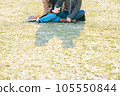 A couple sitting on the lawn 105550844