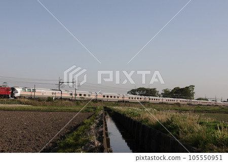 Outbound Cassiopeia train running far beyond rice fields near rice planting 105550951