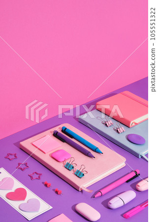 Stationary background with bright magenta, cyan and violet pens, clips and erasers on pink, and purple backdrop. Space for your text. Stationary background with bright magenta, cyan and violet pens, clips and erasers on pink, and purple backdrop. Space for your text. 105551322