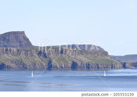 Waterstein Cliffs. The view from a ship as it sails past the coastline of the Isle of Skye near Neist Point Lighthouse. The Isle of Skye is the largests island in the Inner Hebrides of Scotland. Waterstein Cliffs. The view from a ship as it sails past the coastline of the Isle of Skye near Neist Point Lighthouse. The Isle of Skye is the largests island in the Inner Hebrides of Scotland. 105553130