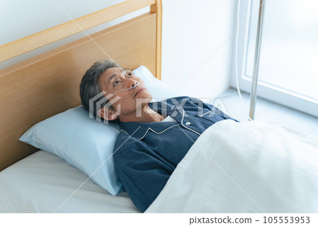 Senior man sleeping on bed with oxygen tube Senior man sleeping on bed with oxygen tube 105553953