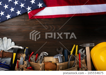Tools hardhat toolbelt and us flag on wooden background labor day banner mockup 105554675