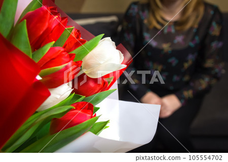 DEFOCUS Tulip women background. Bouquet of colorful tulips with blurred woman on background Happy Mother's Day concept. Women's day. Horizontal. 8 march. Focus on foreground. Out of focus 105554702