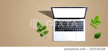Laptop computer with green leaves 105556289