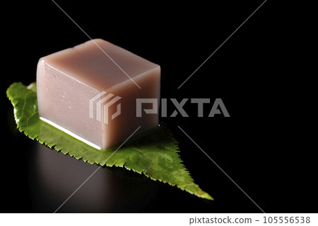 Dice-shaped mizu-yokan on a leaf photographed on a black background Dice-shaped mizu-yokan on a leaf photographed on a black background 105556538